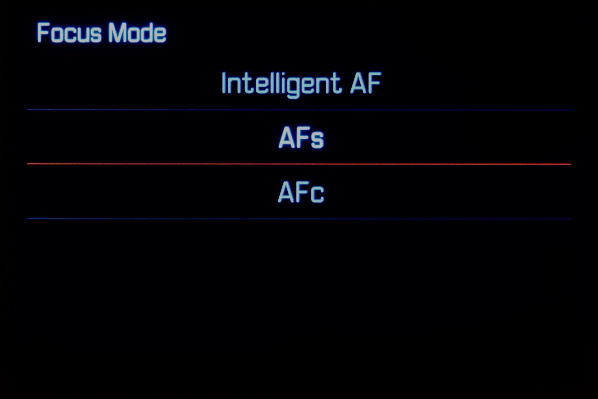 I have not checked which consumes more battery, Intelligent AF or Continuous AF.